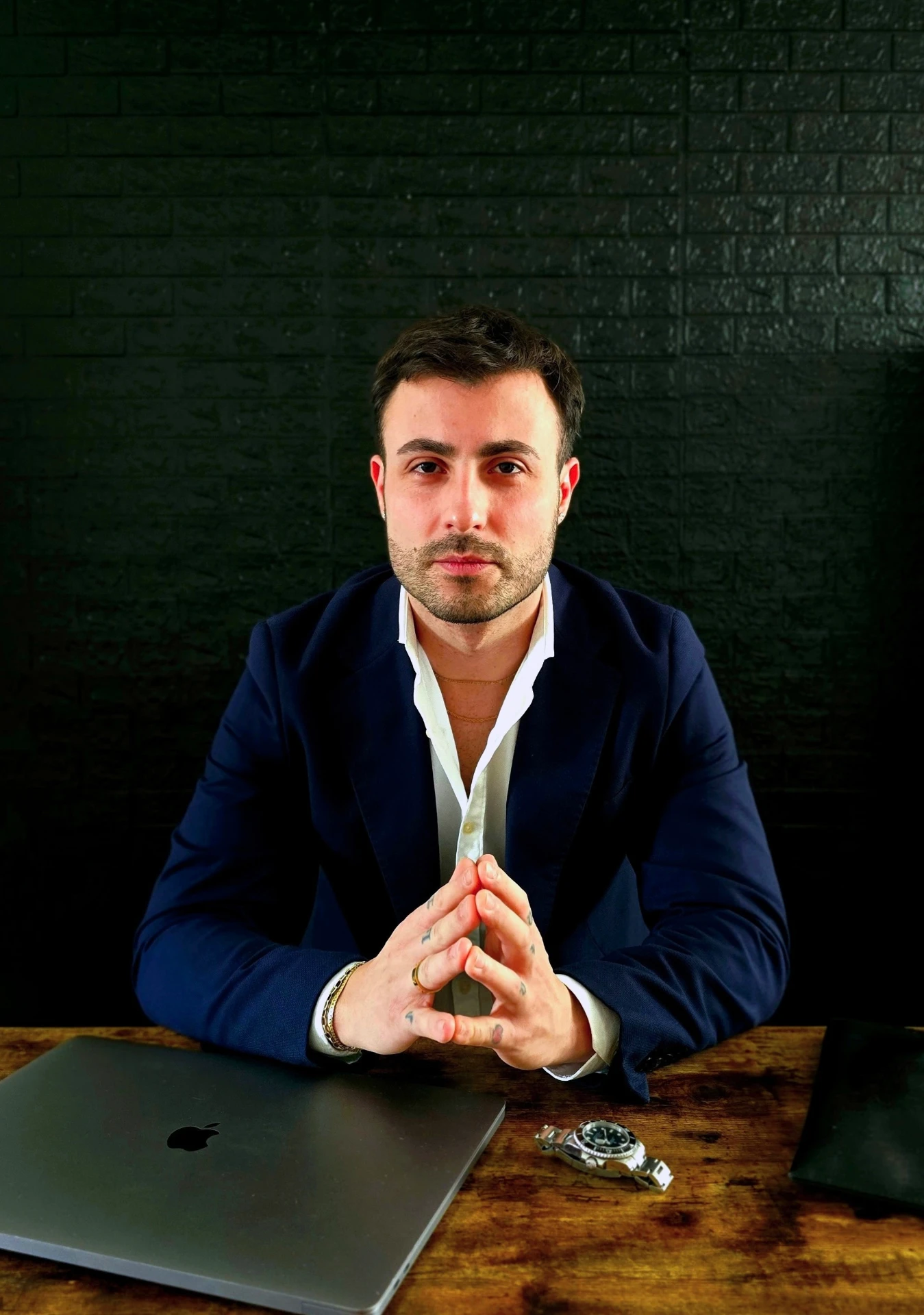 Simone Liggi, founder of Old Man Watches, seated at his desk with a vintage dive watch